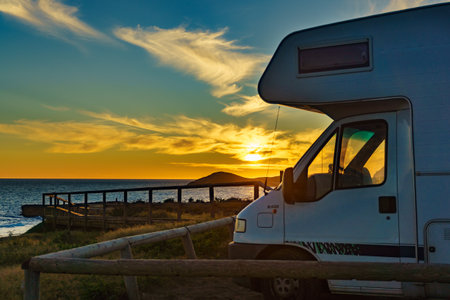 Camper vehicle at sunset on mediterranean coast in Spain. Cala Magre in Calblanque Regional Park, Murcia region. Vacation and traveling in motorhome.の写真素材