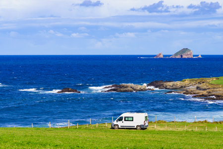 Camper van camping on Verdicio beach west of Cape Penas. Asturias coast, northern Spain. Motor home trip.の写真素材