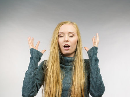 Girl long blonde hair with surprised face expression.の写真素材