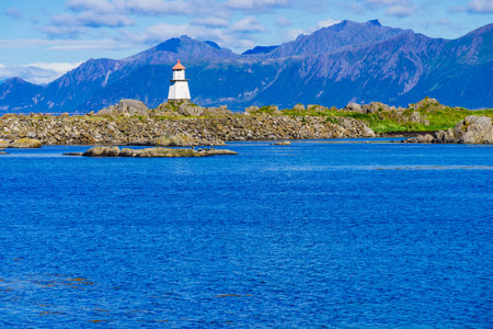 Sea view with lighthouse at Hovsund fishing port, Gimsoya Lofoten Islands in Norway.の写真素材