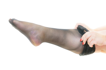 Plus size big chubby woman puts on black nylon stockingsの写真素材