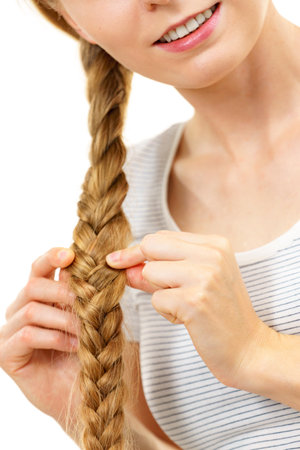 Blonde girl with long braid hair. Haircare, hairstyling, feminine style.の写真素材