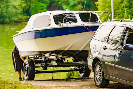 Outdoor activities. Small yacht on car trailer. Boat launchの写真素材