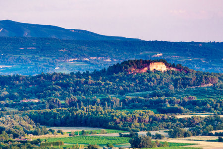 Red rocks of Colorado provencal in Roussillon, Plateau de Vaucluse, Provence in France. View from distance. Summer landscape.の写真素材