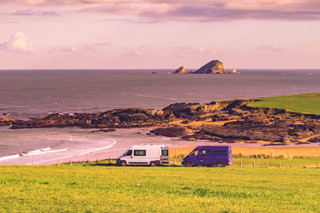Two campervans camping on Verdicio beach west of Cape Penas. Asturias coast, northern Spain.の写真素材
