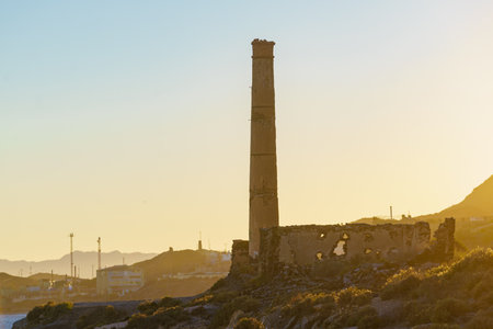 Old aged tall industrial chimney. Abandoned factory after company shut down. Financial crisisの写真素材