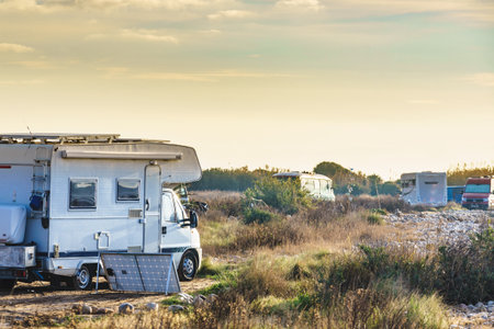 Camper vehicles camping on nature seacoast. Adventure, vacation with mobile home.