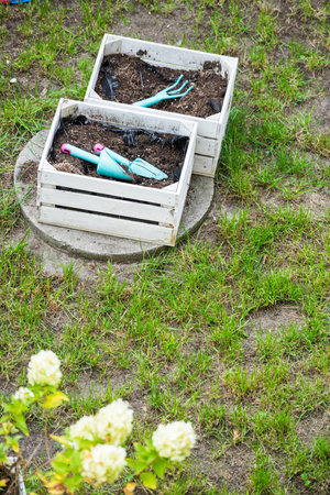 Gardening tools and utensils in wooden boxes for flowers or vegetable planting. Work in the gardenの写真素材