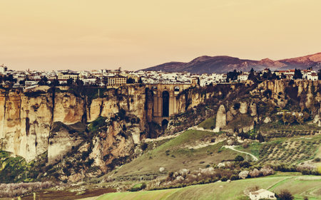 Ronda town and valley, Andalusia, Spain. Popular landmark. Tourist attraction at sunset light, place to visit. View from distance.の写真素材