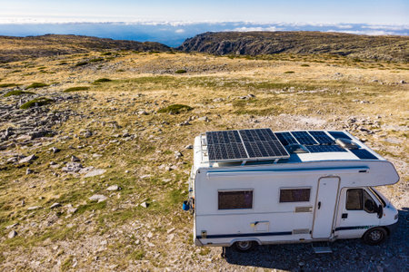 Aerial view of camper with a lot of solar photovoltaic panels on roof camping in mountain nature. Renewable free energy. Elecrticity on caravan holidays.の写真素材