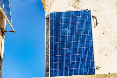 House wal with solar photovoltaic panels, charging batteries. Renewable eco energy concept