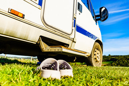 Shoes slippers in front of camper car step. Travel in motorhome, holidays.の写真素材