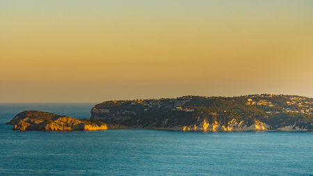 Mediterranean seascape on Costa Blanca. Cape San Antonio with view of Javea coastal town, Alicante province, Spain.の写真素材