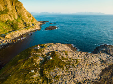 Seascape with lighthouse, rest stop location on Andoya island. Scenic rocky coastline near Nordmela village Vesteralen archipelago, Norway. Aerial viewの写真素材