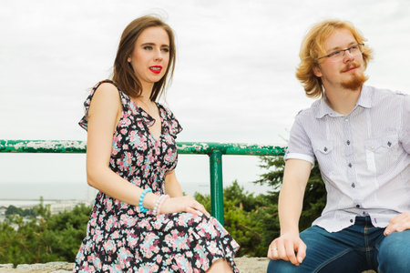 Relationship and dating concept. Young pensive thoughtful couple on date outside