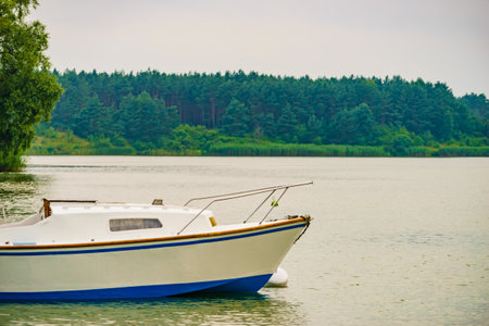 Boat yacht on lake attached to mooring buoy. Tuchola national park in Poland. Yachting, holidays concept.の写真素材