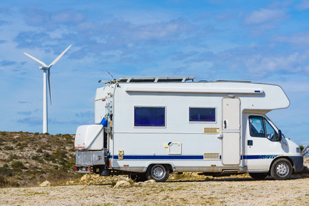 Caravan camping on nature. Wiind turbine in the distance. Aude in the Occitanie region, France. Travel, adventure and holidays concept.の写真素材