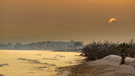 Seaside coastal landscape with urban buildings on horizon. Mediterranean Sea, Costa del Azahar, Spain.の写真素材