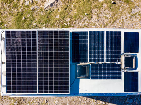 Aerial view of camper with many solar photovoltaic panels on roof camping on nature. Renewable free energy. Elecrticity on caravan holidays.の写真素材