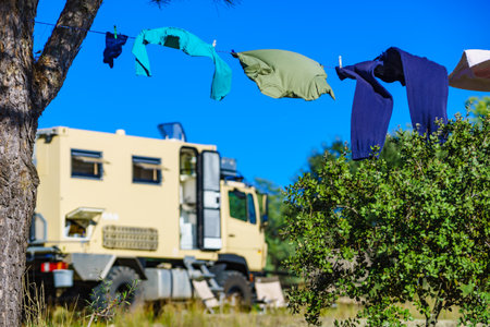 Camping on nature, rv road trip. Laundry clothes hanging to dry by camper, lorry motor home.の写真素材