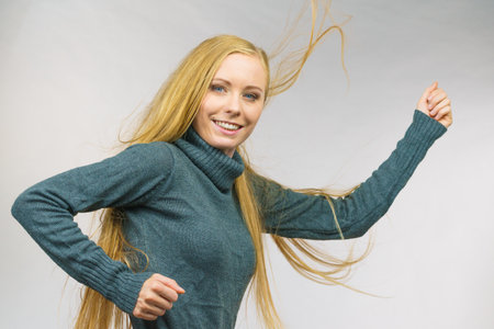 Smiling girl with blowing long blonde hairの写真素材