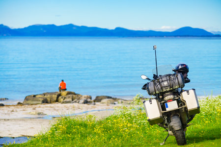 Motorcycle with box case storage on sea shore. Holidays tripの写真素材