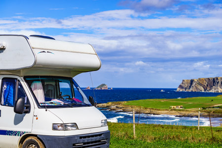 Camper camping on seashore, west of Cape Penas. Asturias coast, northern Spain.の写真素材