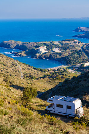 Caravan with solar panels on roof camping on sea coast in Occitania France.の写真素材