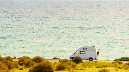 Campervan rv camping on sea shore in Spain. Van life, motor home holidays.の写真素材