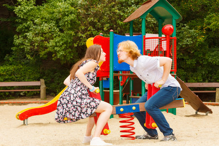 Happy couple having fun together outdoor. Great relationship. Man and woman playing at playground.の写真素材