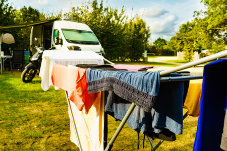 Clothes clean washing laundry hanging to dry on clothesline outdoor, caravan in the background....