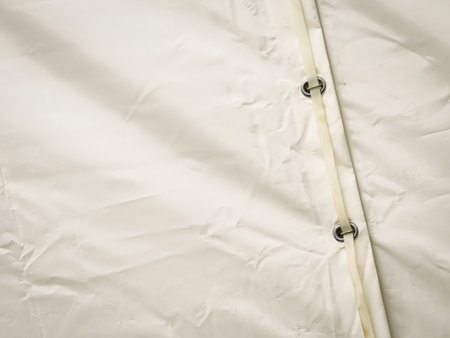 White tarp or waterproof tarpaulin fastened with belt.の写真素材