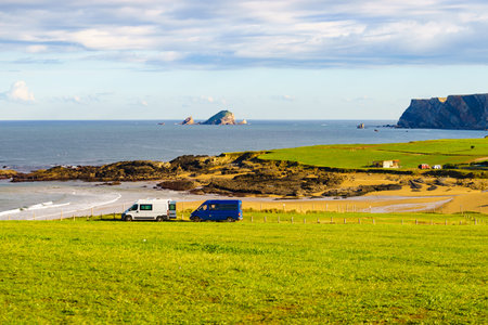 Two campervans camping on Verdicio beach west of Cape Penas. Asturias coast, northern Spain.の写真素材