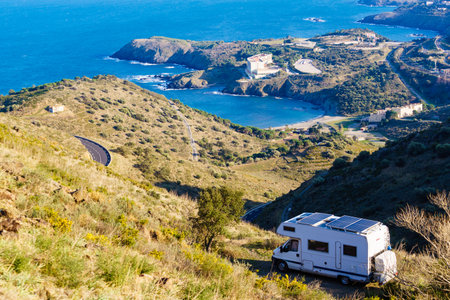 Caravan with solar panels on roof camping on sea coast in Occitania France.の写真素材