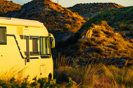 Camper vehicle camping on nature. Adventure, tour with motor home.