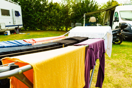 Clothes clean washing laundry hanging to dry on clothesline outdoor, caravan in the background....