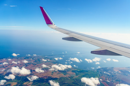 View from an airplane window to Polish coast, Baltic Sea Puck bay and Hel Peninsula. Aircraft flying...