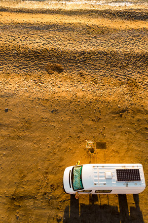Campervan rv camping on beach sea shore. Van life, holidays in Spain. Aerial viewの写真素材