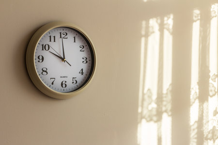 Clock on wall at home showing ten hours. Morning light