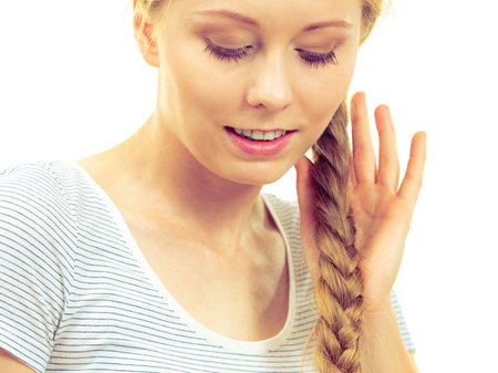 Blonde girl with long braid hair. Haircare, popular hairstyle.