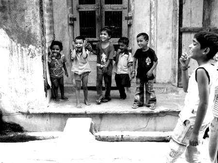 kids playing and looking on something in the streets of sankheda, gujarat, indiaのeditorial素材