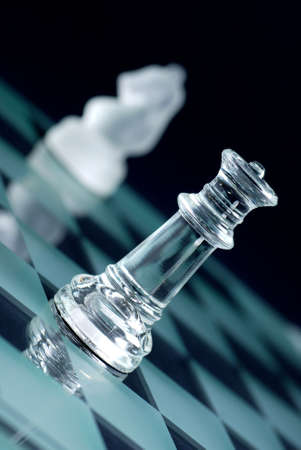 glass chess photographed up close with the black background