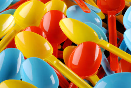 colored plastic spoons photographed up closeの写真素材