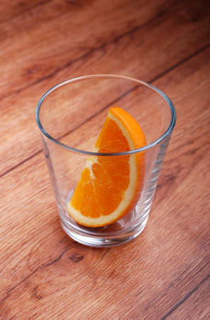 slice of orange in the glass beakerの写真素材