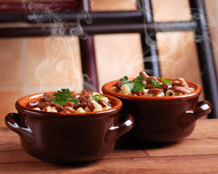 pasta and beans in earthenware bowl