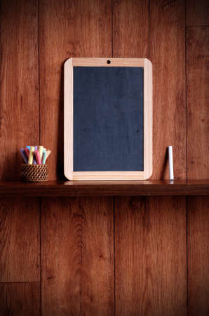 small blackboard on wooden shelfの写真素材