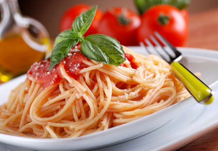 spaghetti with tomato sauce with basil leafの写真素材