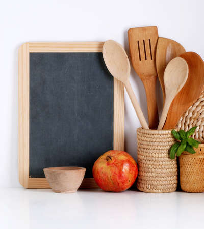 Kitchenware with blackboard on white wallの写真素材