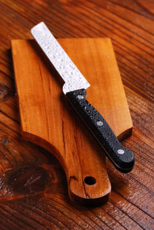 wooden cutting board with knife