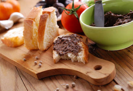 black olive pate spread on slice of bread